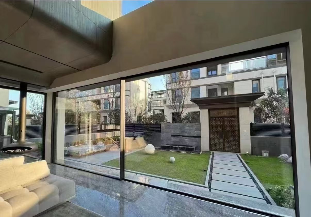 Floor-to-ceiling ABTE panoramic aluminum sliding door in a modern villa